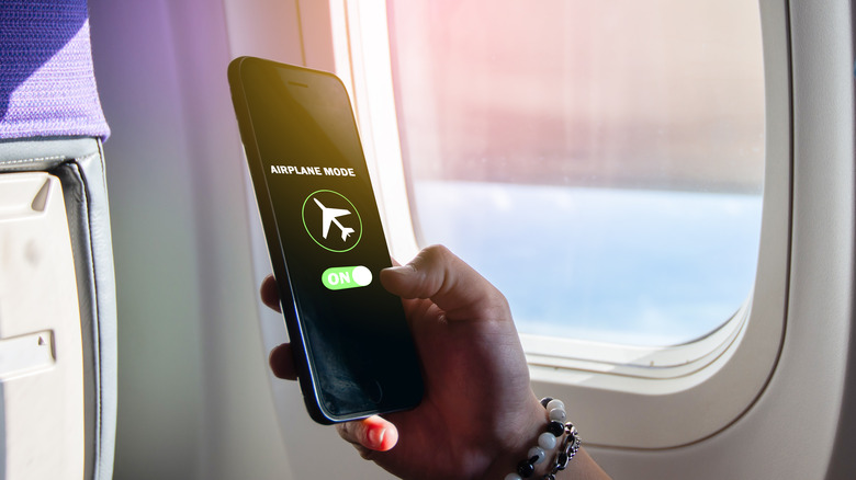 Person turning on airplane mode