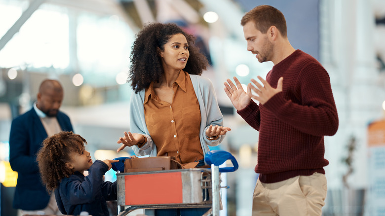 Couple arguing in an airport terminal