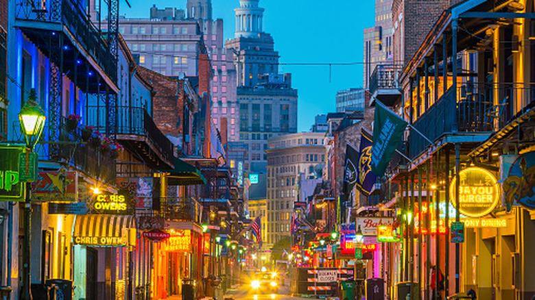 A street view of the New Orleans French Quarter with neon lights