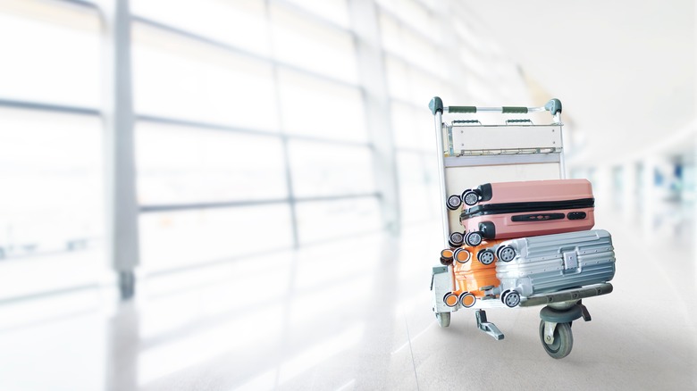 A trolley filled with suitcases in an airport