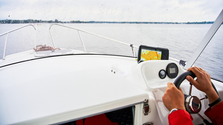 Inside view of boat cockpit looking out over lake