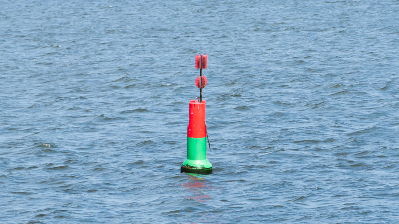 Red and green striped buoy on the water