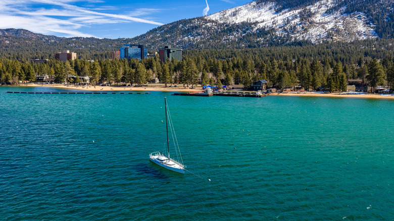 A boat sailing on Lake Tahoe, California with mountains in background