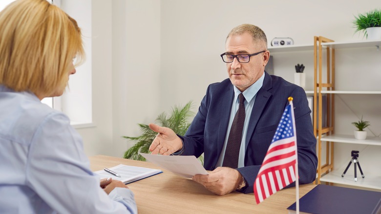 U.S. Consulate worker looking over visa application