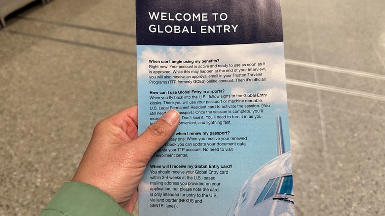 Person holding a Global Entry brochure