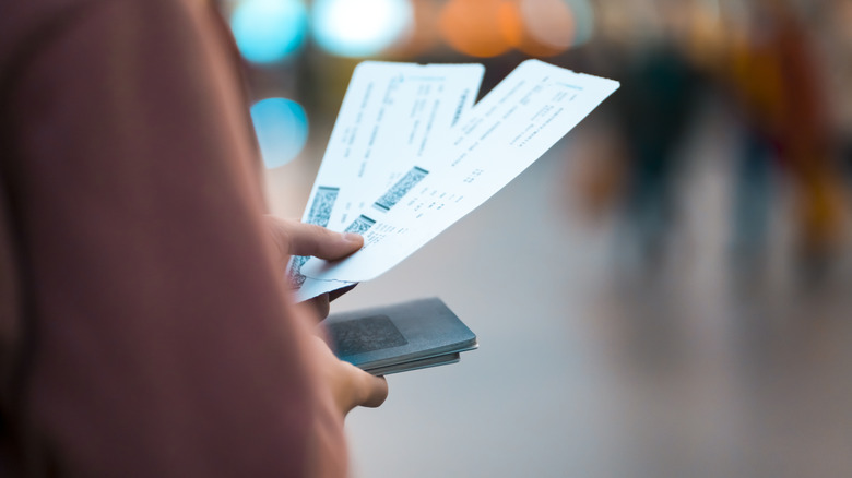 person looking at boarding pass