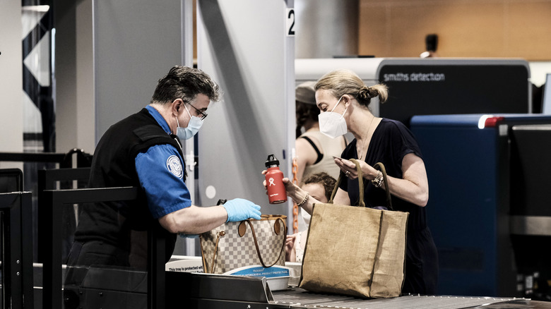 TSA agent checking passenger's bags