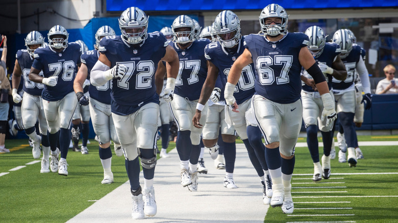 Dallas Cowboy football players taking the field