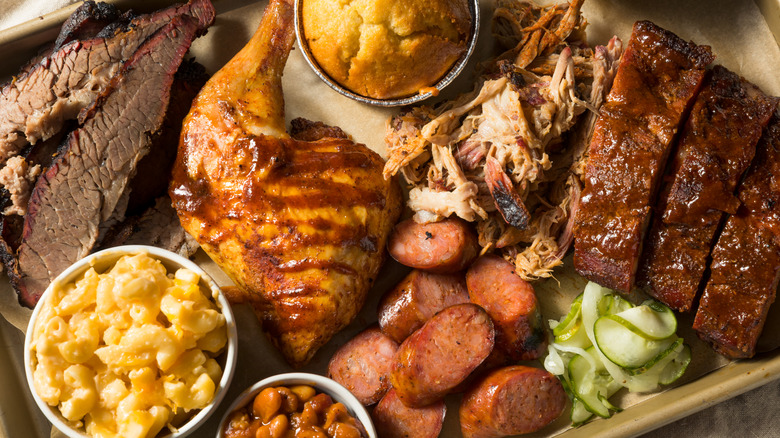 A platter of Texas barbecue with chicken, ribs, brisket, and sides