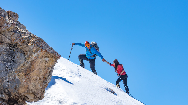 Two climbers heading up a steep incline
