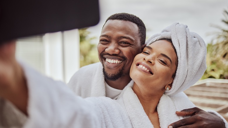 Couple taking pics in hotel robes