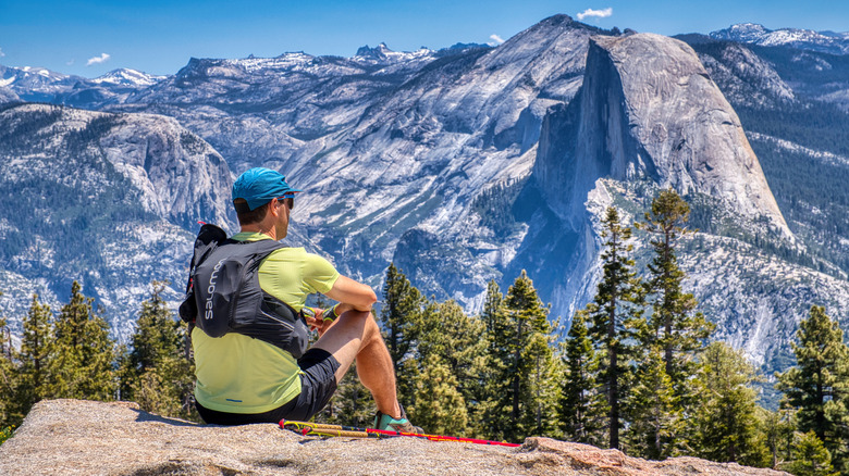 A hiker takes in the view from Sentinel Dome in Yosemite National Park.
