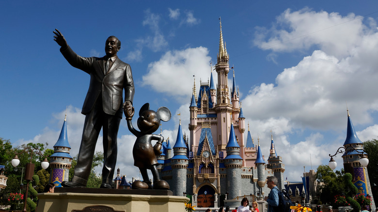 The Mickey and Walt Disney statue and the castle at Magic Kingdom