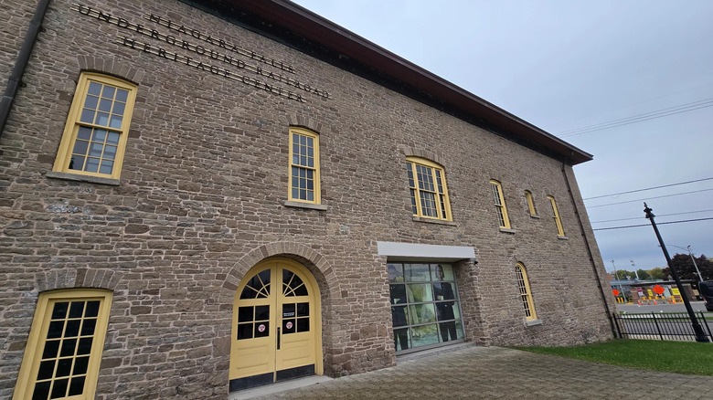Exterior of Niagara Falls Underground Railroad Heritage Center, a brick building with a yellow door and windows