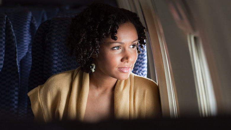 Woman in the window seat of a plane