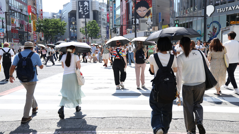 People brave the heat with umbrellas in Tokyo