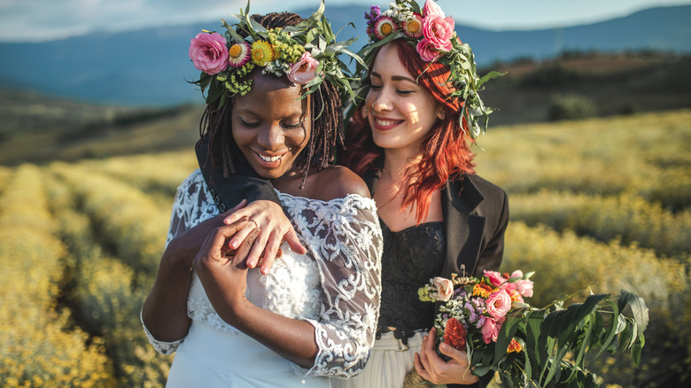 Two brides in a field