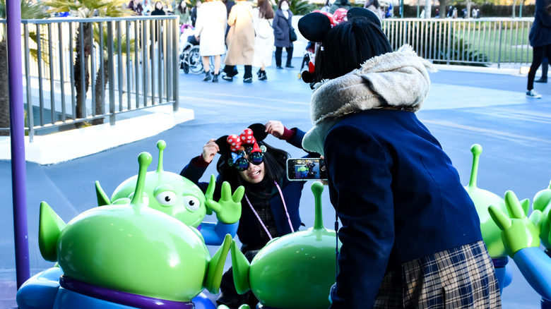 Toy Story Aliens and excited visitors at Tokyo Disneyland