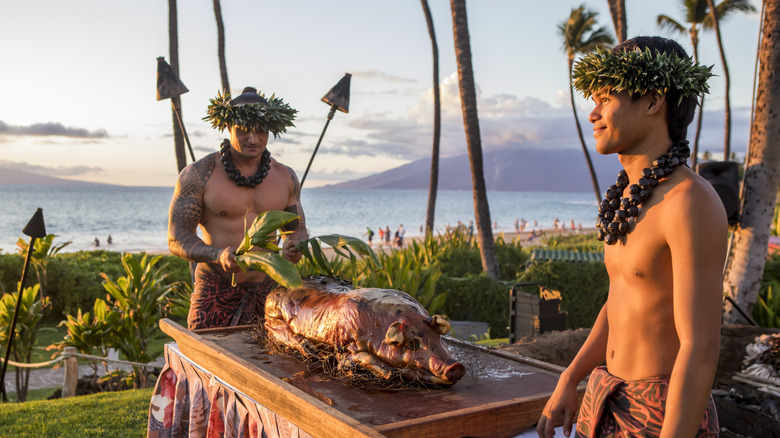 Hawaiians preparing roast pig on Maui