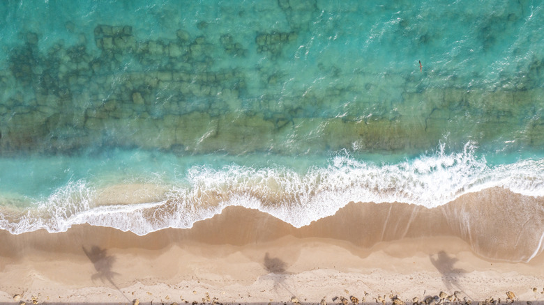 Ocean water and beach in Florida with crashing waves.