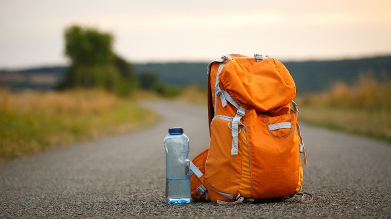 water next to backpack