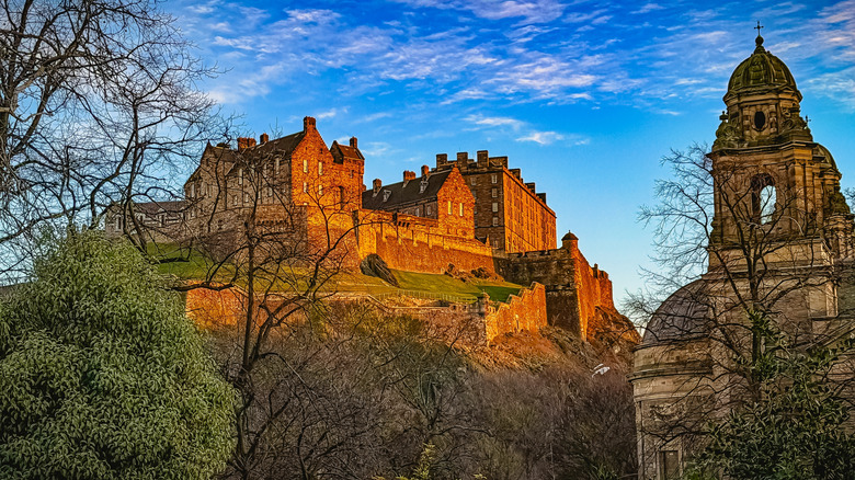 Ground-level view of Edinburgh Castle during sunset