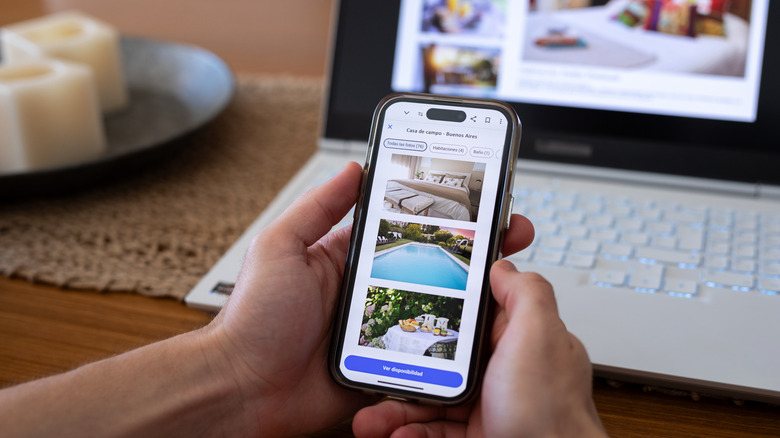 Someone booking accommodation on a phone app.