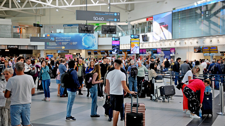 Travelers inside a busy airport
