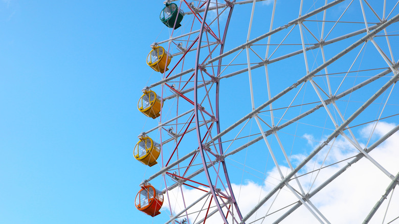 A colorful Ferris wheel against a blue sky