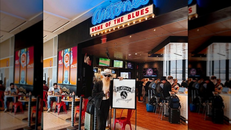 A man standing outside the entrance of Antone's in the Austin airport