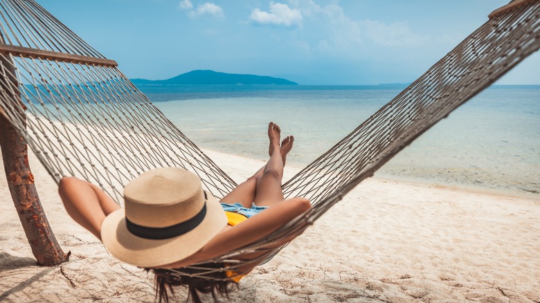 Traveler lounging alone on a beachfront hammock