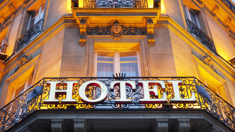 A lit hotel facade at night in Paris, France