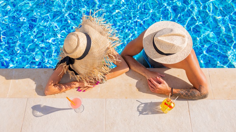 A couple lounging in the pool