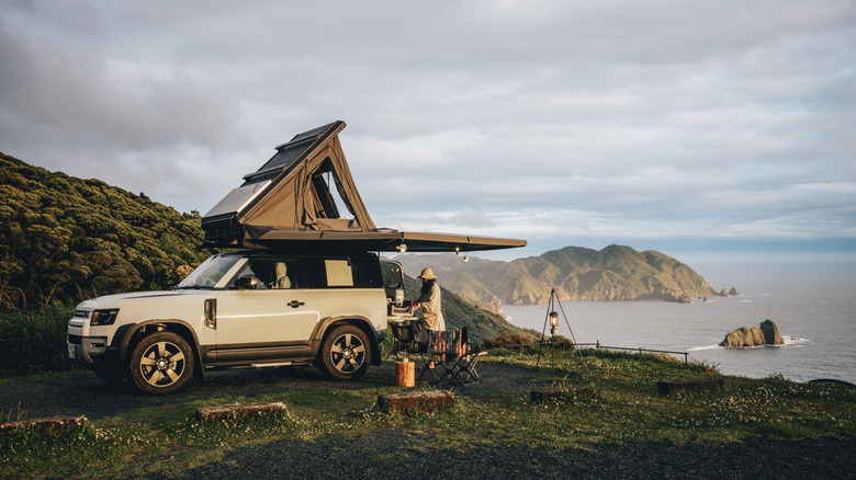 Couple camping with a rooftop tent