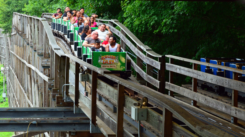 Park guests ride the wooden Boulder Dash coaster