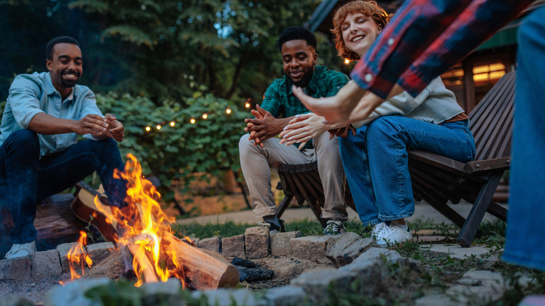 A group of friends sitting around a campfire