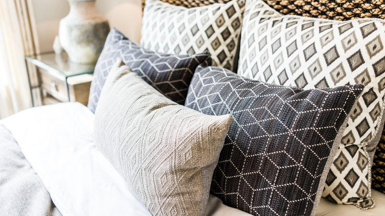 Multiple pillows on a hotel bed