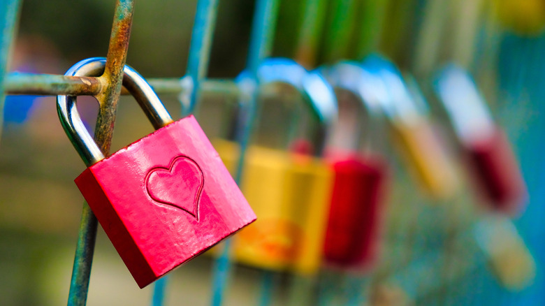 A lock on a bridge with a heart engraved into it