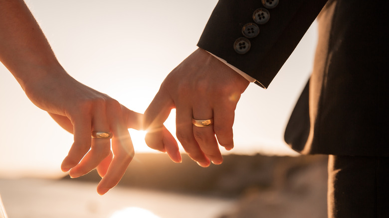 A married couple holding hands