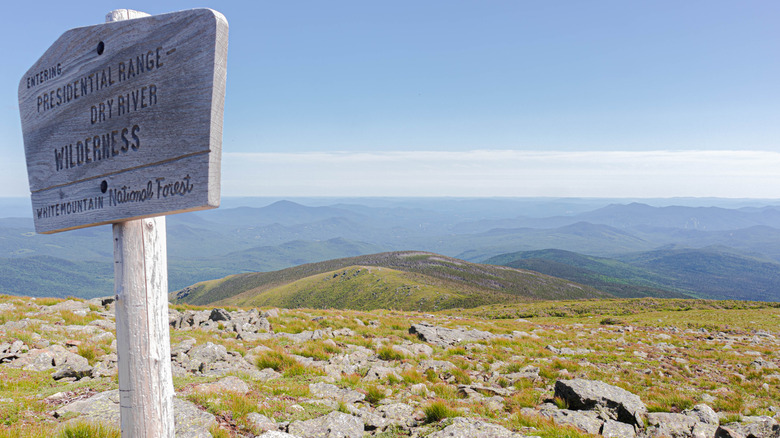 A trail marker beside a boulder field along the Presidential Traverse in New Hampshire's White Mountains