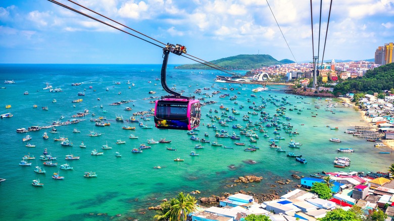 The Hòn Thơm cable car traveling over boat-filled water in Phú Quốc