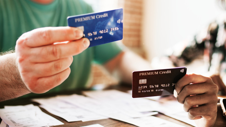 Person holding two different credit cards