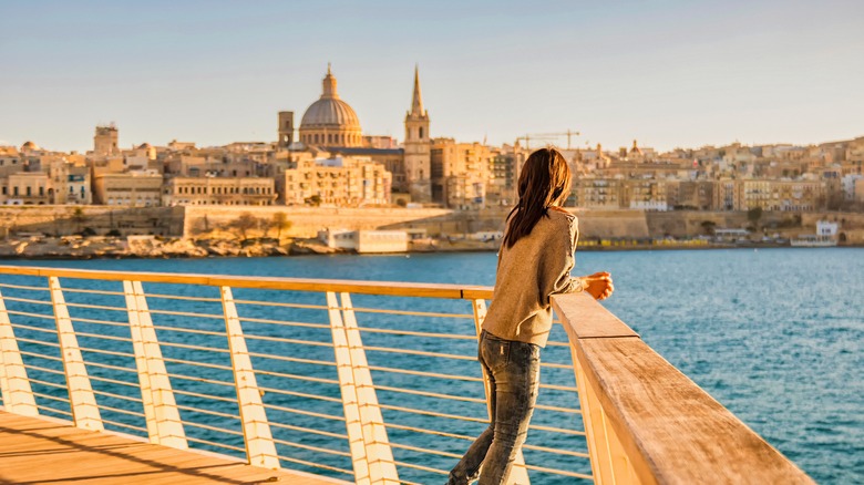 Woman looks towards Valletta