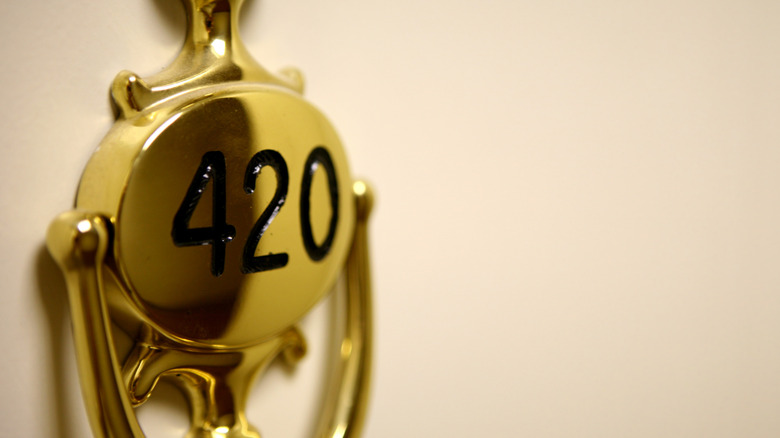 a hotel room knocker with the number 420 on it