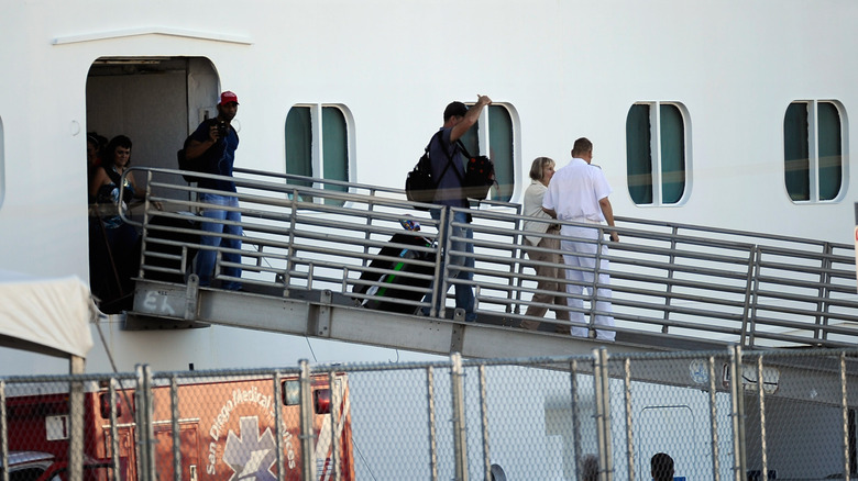 passengers disembarking from a Carnival cruise ship