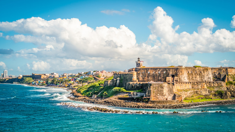the San Juan skyline pictured from off the coast, with the Castillo San Felipe del Morro castle in focus