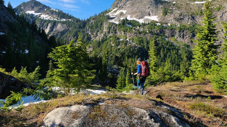 A woman hikes through North Cascades National Park along the Pacific Crest Trail in Washington