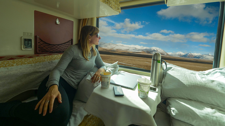 Woman on bed in a sleeper train