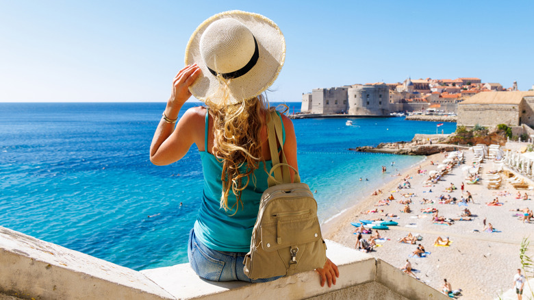 A woman with a travel bag in Dubrovnik, Croatia