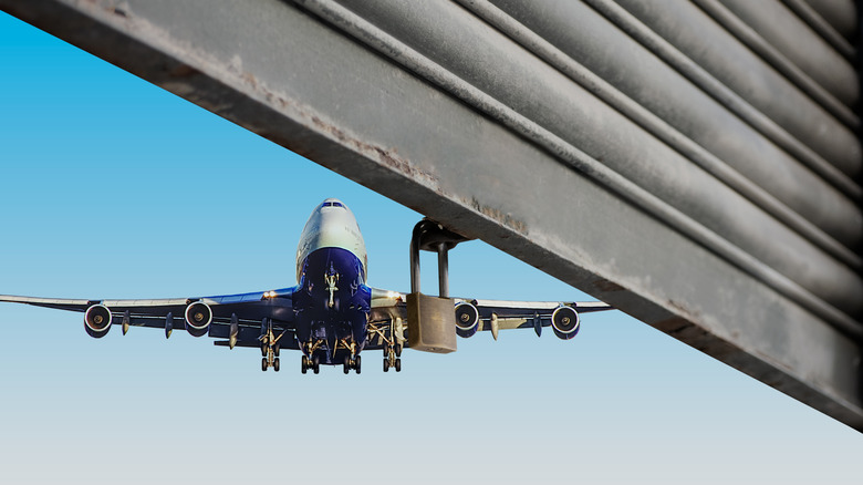 An airplane flies near hangar